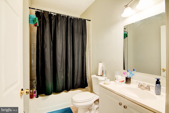 full bathroom featuring a textured ceiling, toilet, vanity, and shower / tub combo with curtain