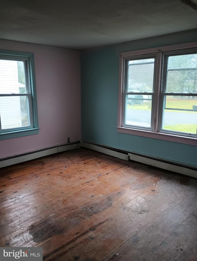 empty room with dark wood-type flooring and a healthy amount of sunlight