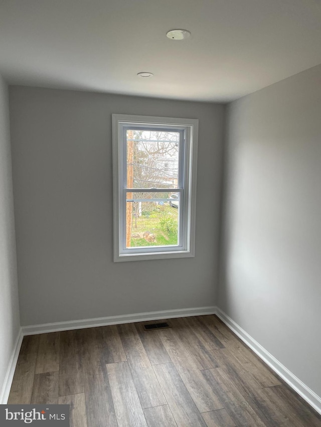 unfurnished room with hardwood / wood-style floors