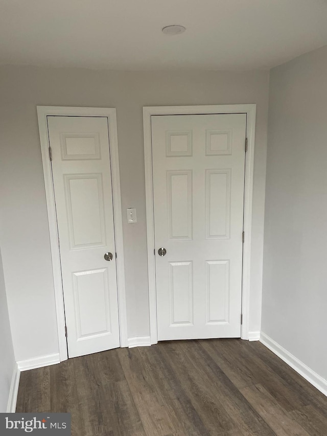 unfurnished bedroom featuring dark wood-type flooring