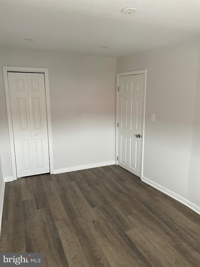 spare room featuring dark hardwood / wood-style flooring