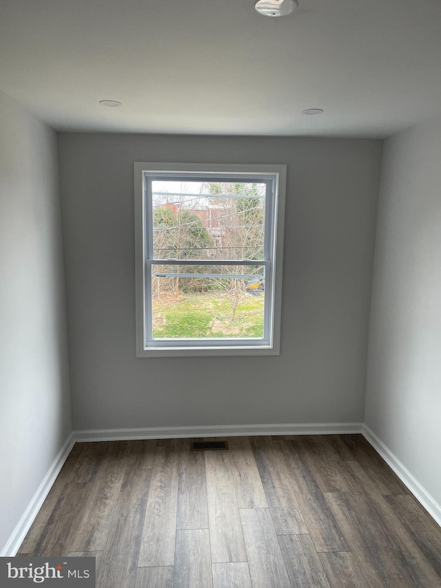 unfurnished room featuring dark hardwood / wood-style flooring