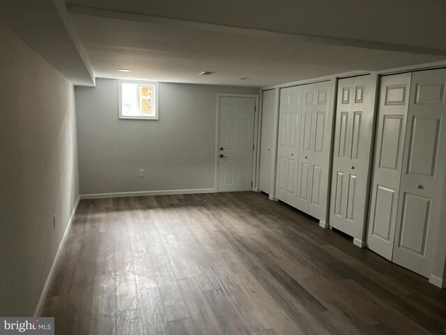 basement featuring dark hardwood / wood-style floors