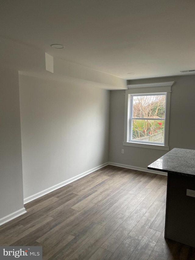 unfurnished room featuring dark hardwood / wood-style floors