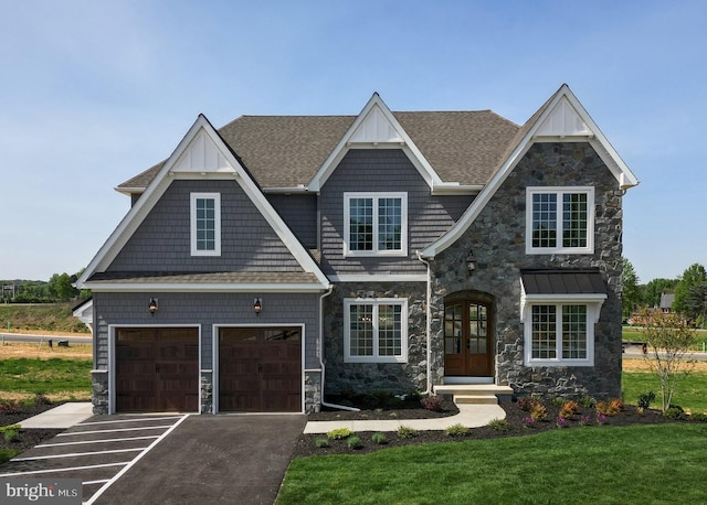 view of front facade with driveway, french doors, roof with shingles, stone siding, and a front lawn