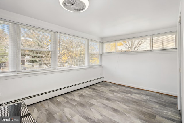 unfurnished sunroom featuring baseboard heating