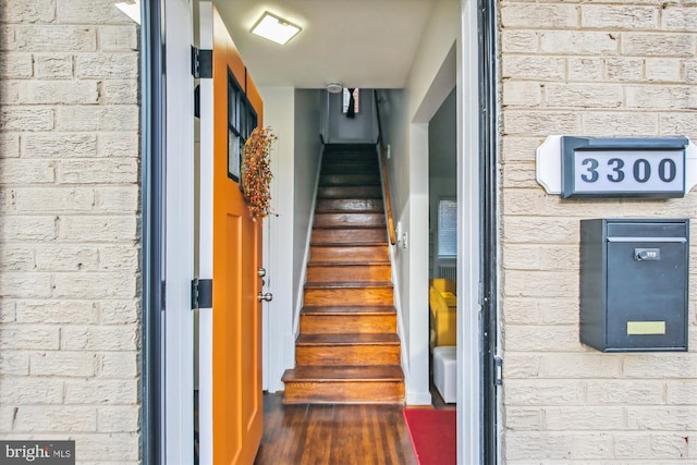 stairs featuring brick wall