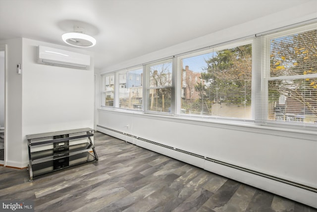 interior space with dark hardwood / wood-style flooring, baseboard heating, a wall mounted AC, and a healthy amount of sunlight