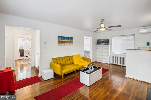 living room with ceiling fan, a wall mounted air conditioner, dark hardwood / wood-style floors, and radiator