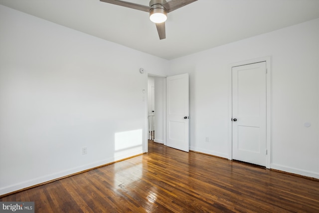 unfurnished bedroom with dark hardwood / wood-style floors and ceiling fan