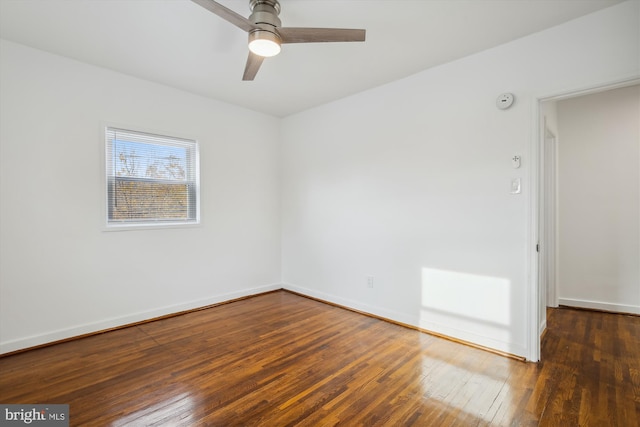 empty room featuring dark hardwood / wood-style flooring and ceiling fan