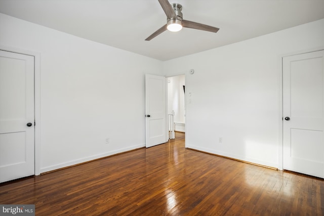 unfurnished bedroom featuring ceiling fan and dark wood-type flooring