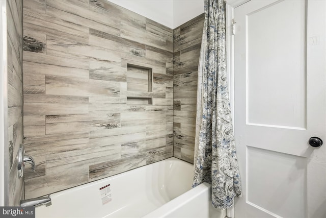 bathroom with shower / bath combo with shower curtain