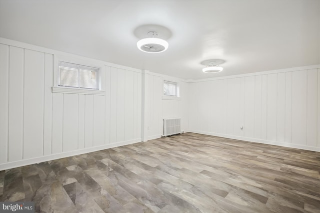 interior space featuring radiator heating unit and hardwood / wood-style flooring