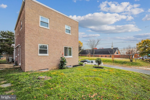 view of side of home with a yard