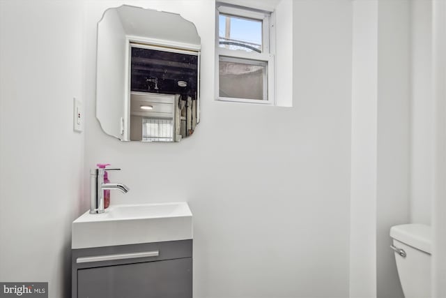 bathroom featuring toilet and vanity