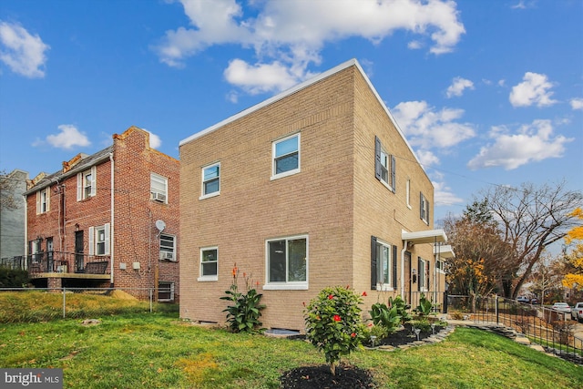 rear view of property featuring a yard