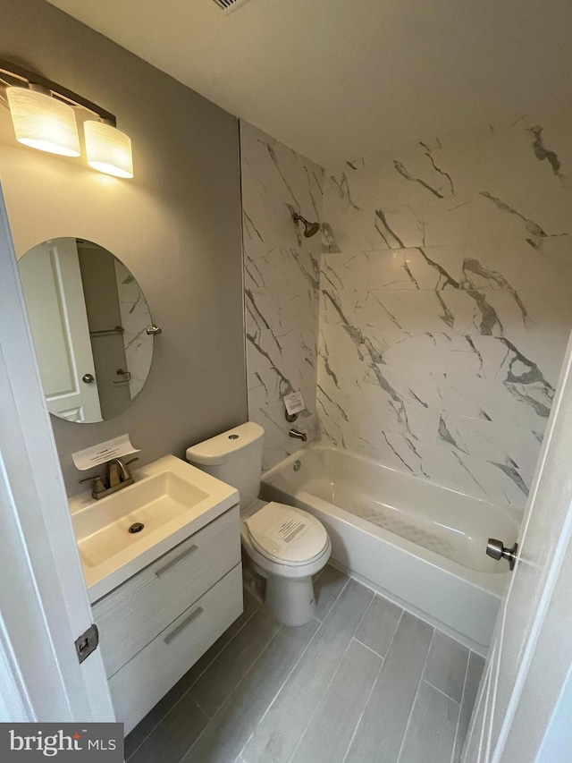 full bathroom featuring tiled shower / bath combo, tile flooring, toilet, and vanity