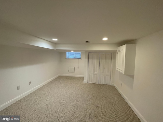 basement with light colored carpet