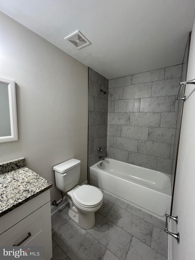 full bathroom featuring toilet, tile flooring, tiled shower / bath combo, and vanity