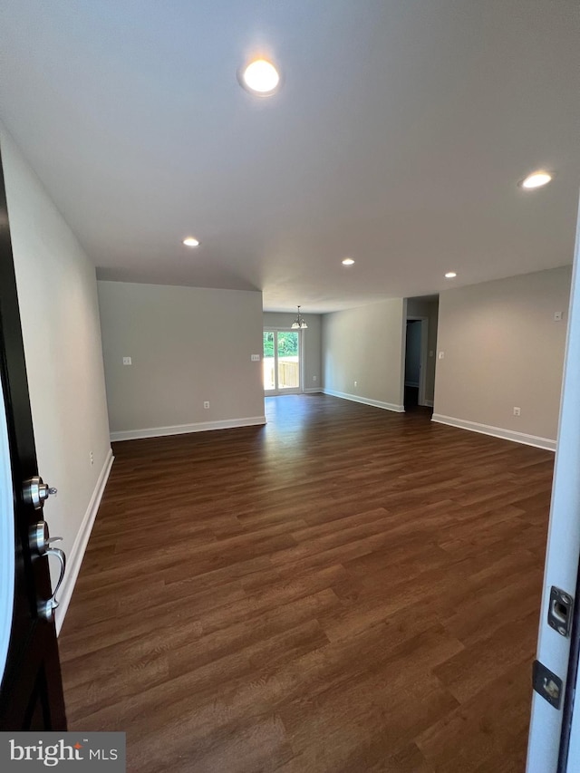 empty room featuring dark hardwood / wood-style flooring