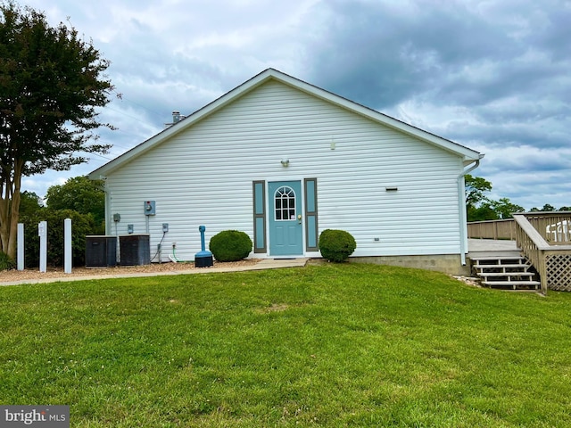 exterior space with a wooden deck, central AC unit, and a front yard