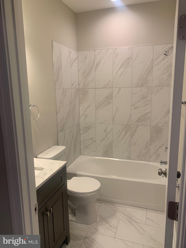 full bathroom with tile flooring, toilet, tiled shower / bath combo, and vanity