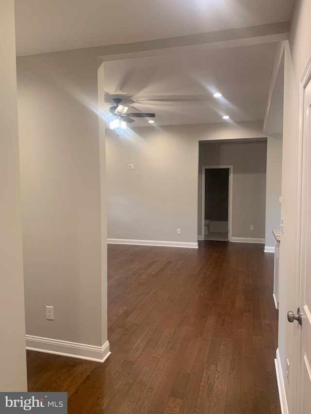 empty room featuring ceiling fan and dark hardwood / wood-style flooring