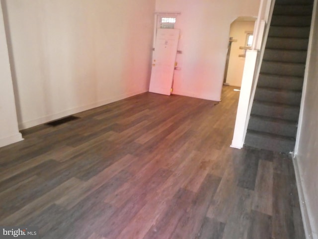 unfurnished room featuring dark wood-type flooring