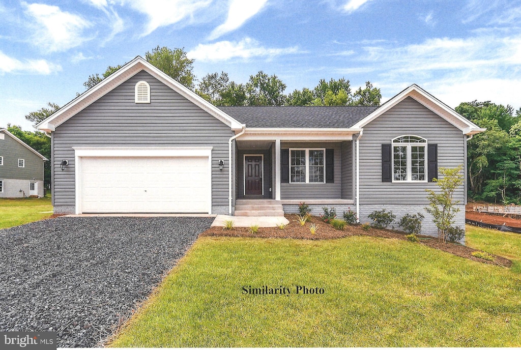 single story home with a garage, a front yard, and driveway