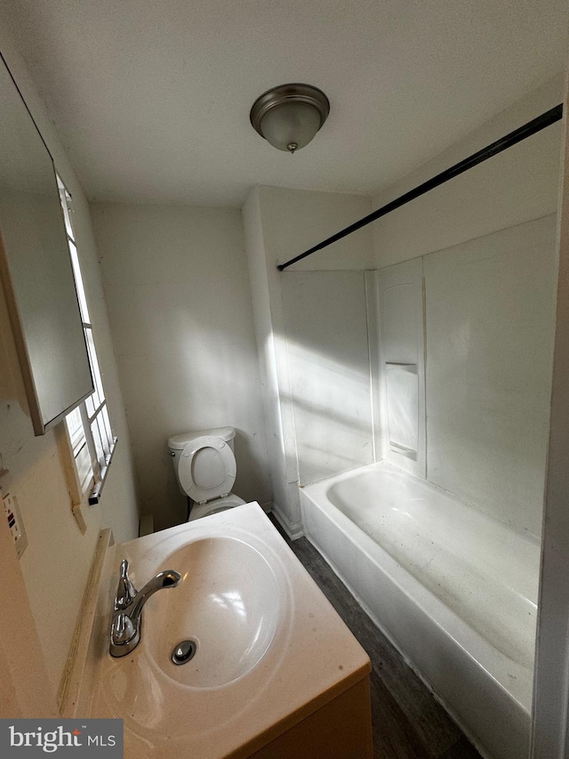 full bathroom featuring shower / bathing tub combination, toilet, and sink