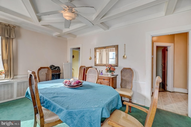 dining area with coffered ceiling, light carpet, radiator, ceiling fan, and beam ceiling