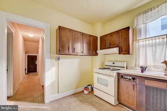 kitchen with light tile flooring and white gas range