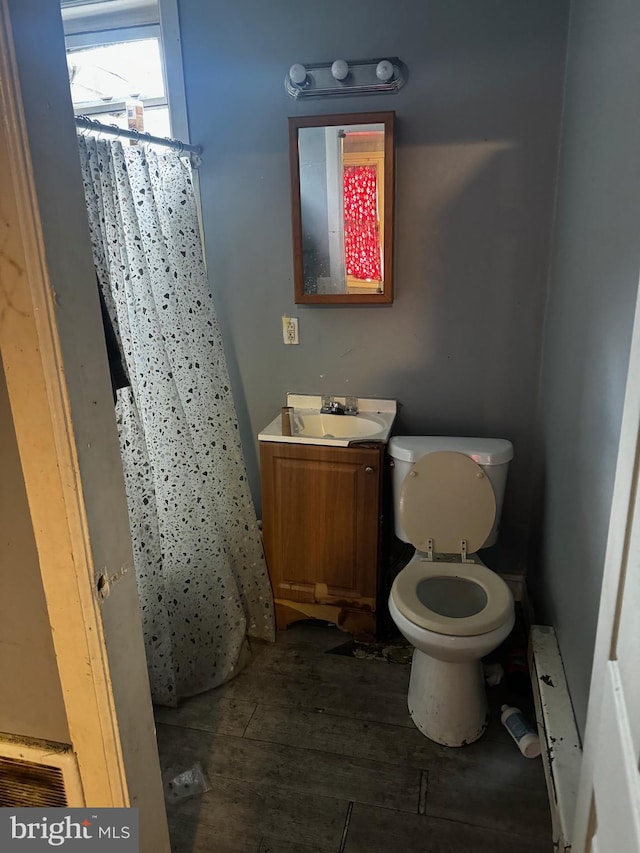 bathroom featuring toilet and vanity