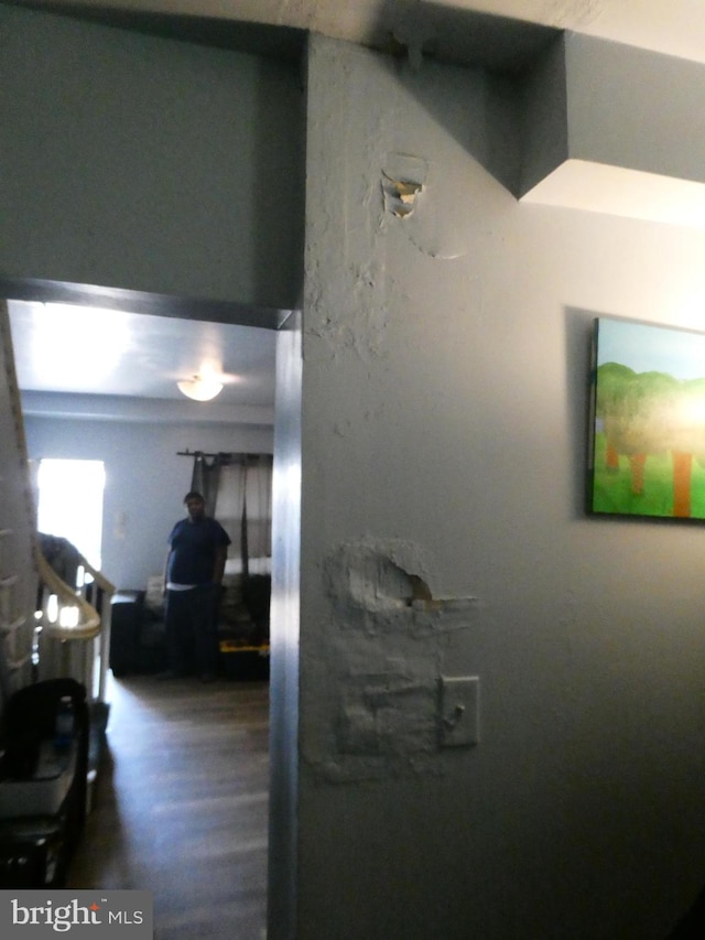 hallway with hardwood / wood-style flooring