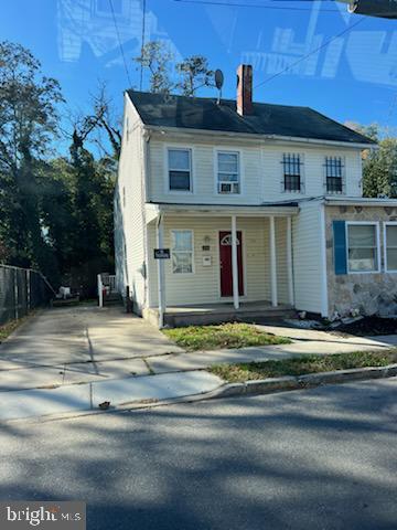 208 S Pine St, Bridgeton, NJ 08302 - view of front of home featuring a chimney, a porch, and driveway
