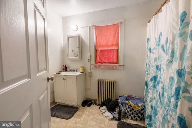 bathroom with vanity, curtained shower, and radiator