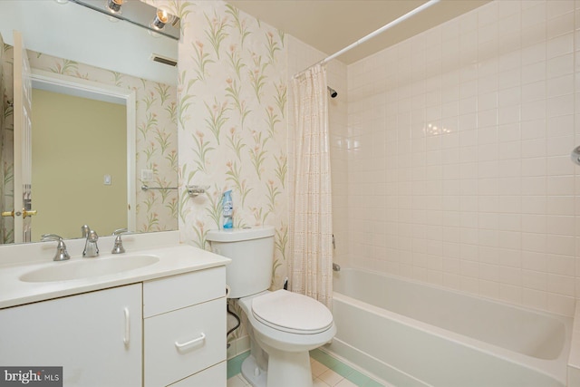 full bathroom featuring tile patterned flooring, shower / bath combo with shower curtain, vanity, and toilet