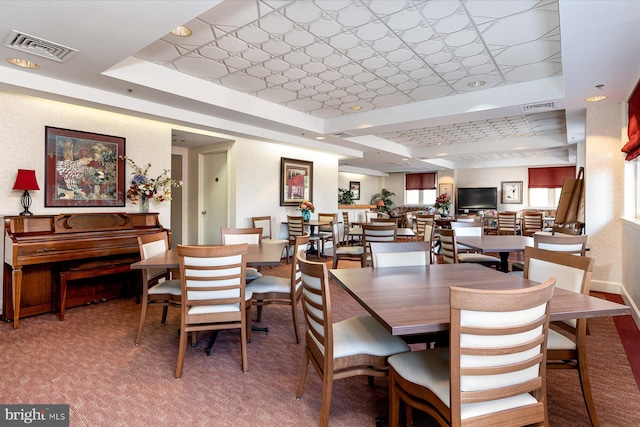 dining area with a tray ceiling