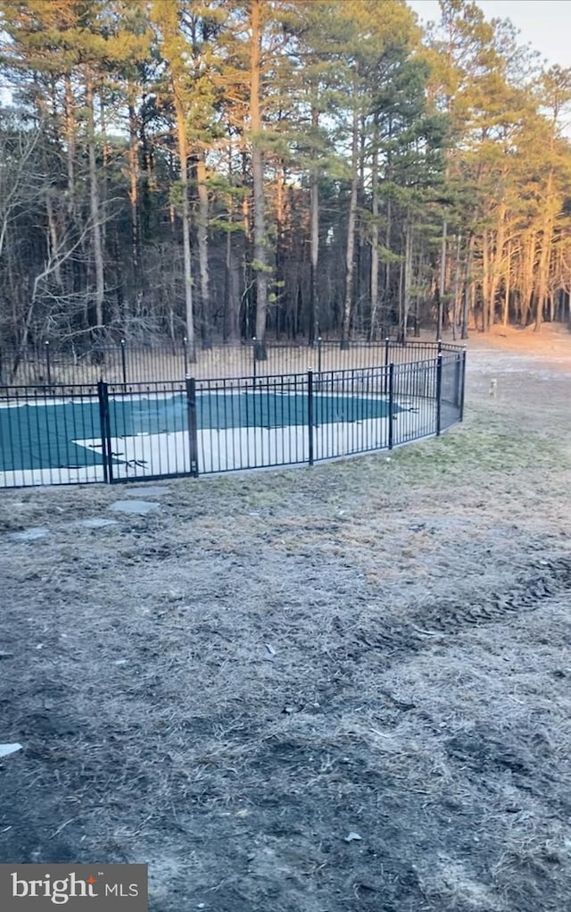 view of swimming pool featuring a pool and fence