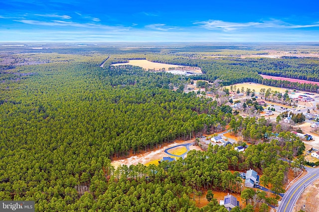 drone / aerial view featuring a wooded view