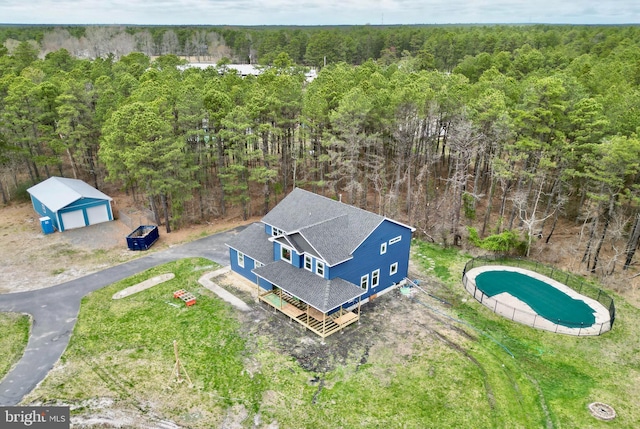 drone / aerial view featuring a forest view