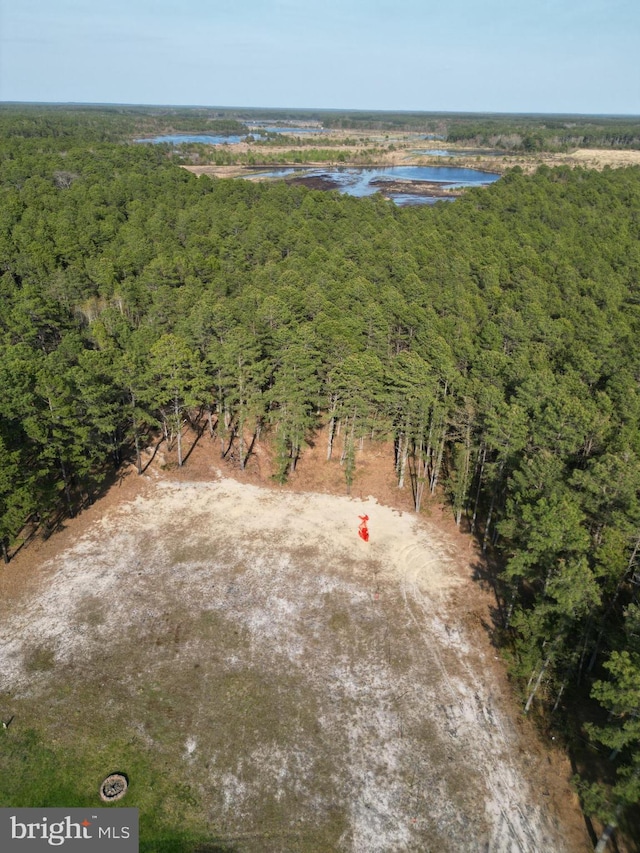 aerial view with a forest view and a water view