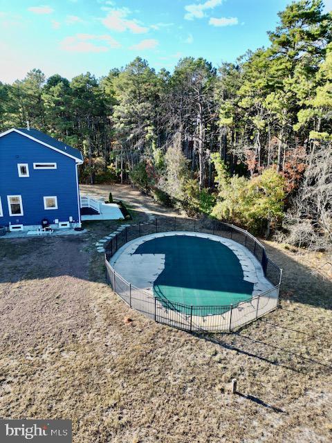 view of pool featuring fence