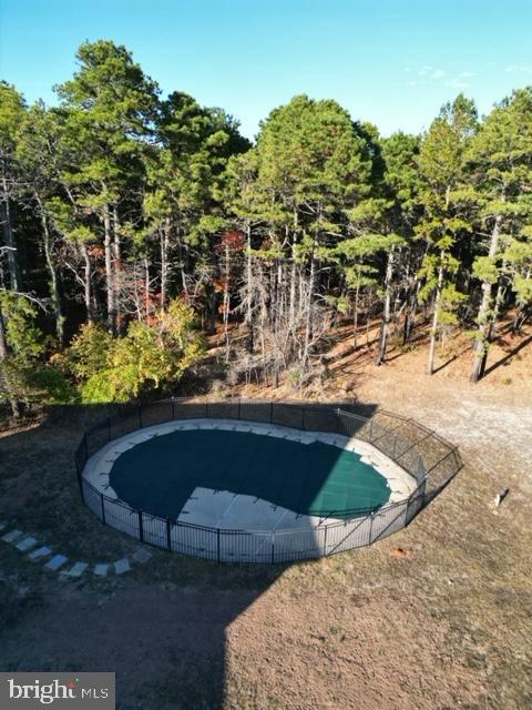 view of pool with a fenced in pool and fence