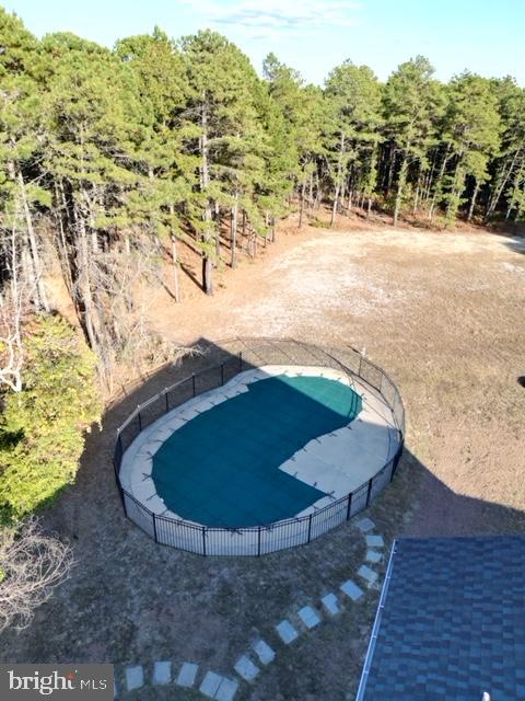 view of swimming pool featuring fence