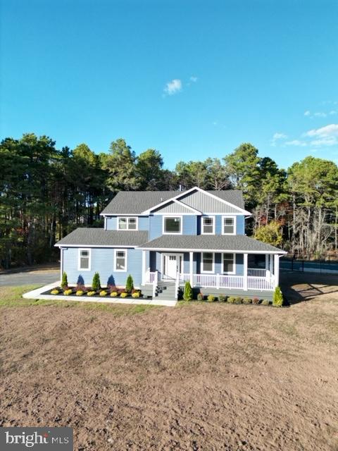 view of front of property with a porch and a front lawn