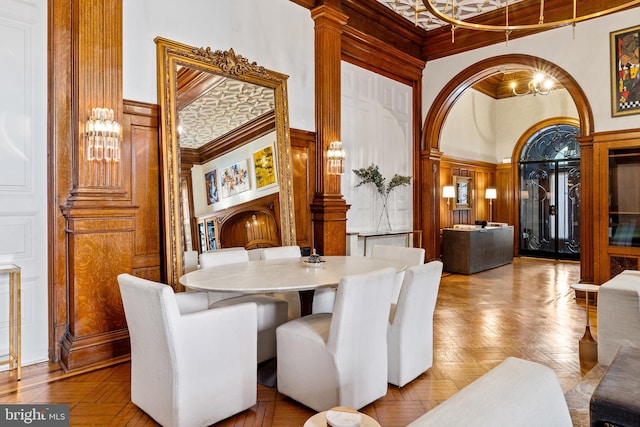 dining room with a chandelier, a high ceiling, and light parquet floors