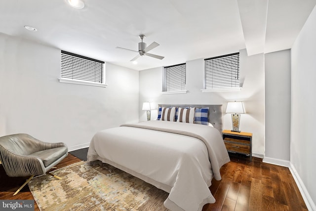 bedroom with dark hardwood / wood-style flooring and ceiling fan