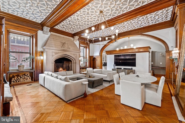 living room with a wealth of natural light, a fireplace, and a high ceiling